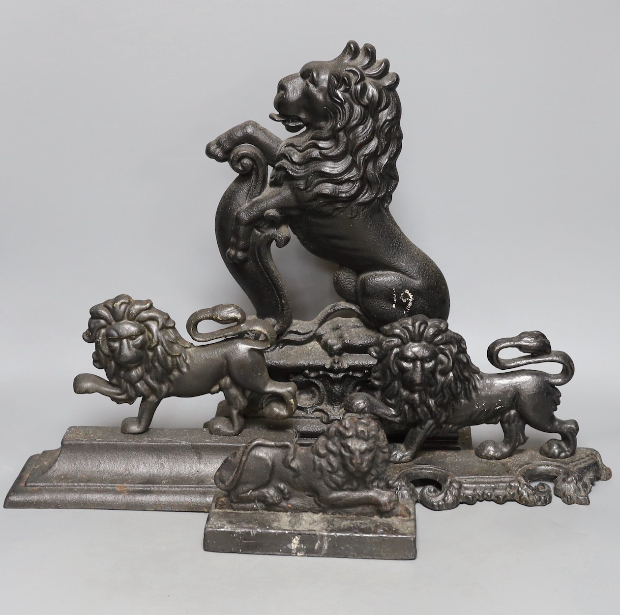 Four cast iron ‘lion’ door stops, 39cm